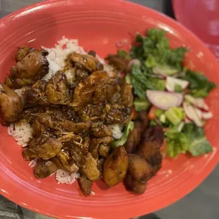 Jerk chicken with plantains, rice and salad. Very flavorful.