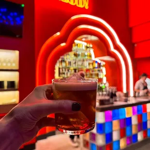 a hand holding a glass of beer