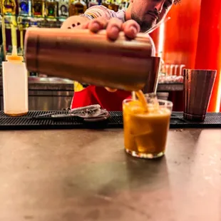 a bartender pouring a drink