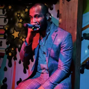 Singer on stage at karaoke bar