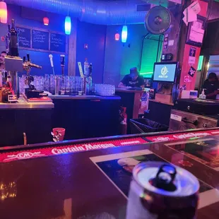 a can of beer on a bar counter