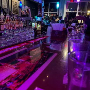 a bar with purple lighting