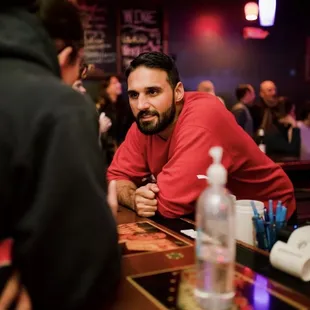 Bartender serving drinks at karaoke bar