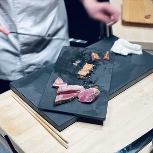 a chef preparing food on a cutting board