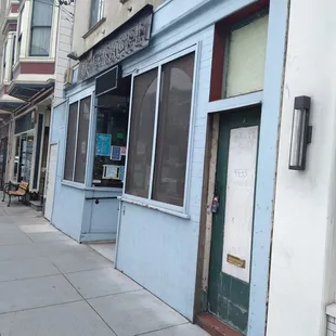 an empty sidewalk in front of a building