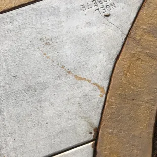 Sloppy stain on driveway and crack