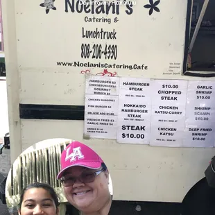a woman and a man in front of a food truck