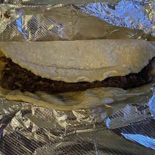 Barbacoa (slow cooked beef) on homemade corn tortillas taco.