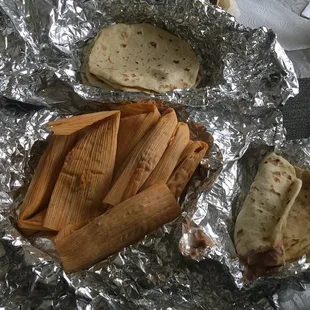 Dozen of flour tortillas, dozen of pork tamales, one egg and bean breakfast taco.