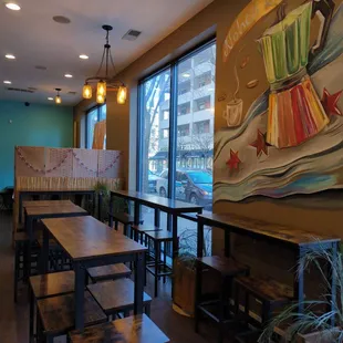 tables and benches in front of a large window