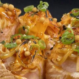 La Bomba Dinamita Salmon Sashimi
Yuzu dressed salmon sashimi, wrapped around sushi rice with krab mix and spicy mayo and torched