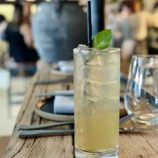 a glass of lemonade on a wooden table