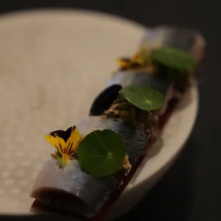 a white plate with a piece of food on it