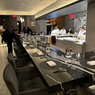 a long dining table with place settings