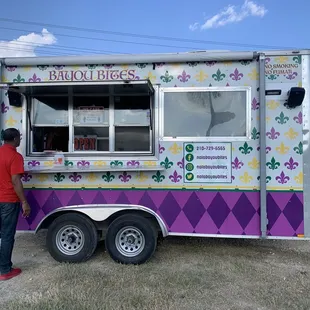 a man standing in front of a food truck