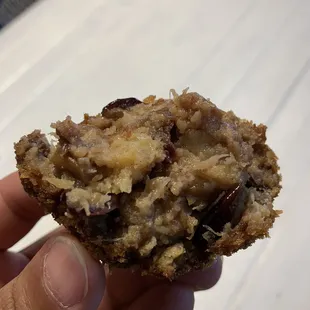 a hand holding a half eaten food item