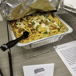 a tray of pasta with a fork in it