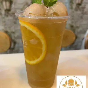 a cold drink with orange slices and mint