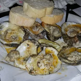 Oysters on the half shell, broiled over an open flame. Cooked in a garlic butter sauced topped with romano/parmesan  cheeses.