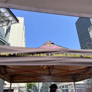 a man standing under a tent