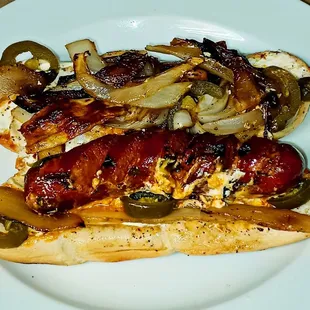 a hot dog with onions and peppers