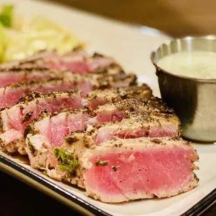 Tuna Tartar crusted in black peppercorn w/wasabi sauce &amp; iceberg lettuce with a ginger/soy dressing. Superb :)...