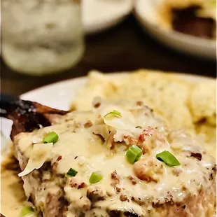 Pork Chop &amp; grits smothered in creamy crawfish &amp; shrimp &quot;Lafitte sauce&quot; topped w/fresh shaved Parmesan cheese. Superb. Winners Circle :)...