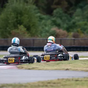 Two racers battle for position on the karting track for a local sprint kart series.
