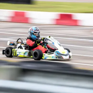 A racer flies down the straight on the karting track.