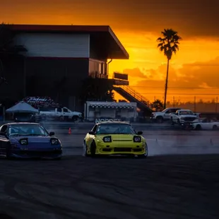 Two cars drifting on the Skid Pad at NOLA Motorsports Park for a local drift event.