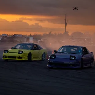 Two cars drifting on the Skid Pad at NOLA Motorsports Park for a local drift event.