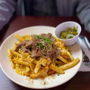 a plate of pasta with meat and cheese