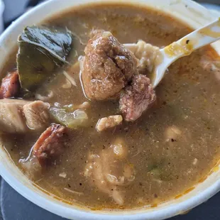 a bowl of soup with meat and vegetables