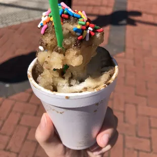 a cup of ice cream with sprinkles