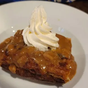 Bread pudding topped with a rum sauce and homemade whipped cream