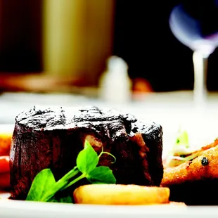 a plate of food and a glass of wine