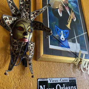 a mask and a new orleans street sign