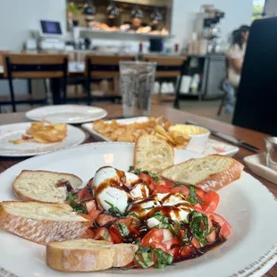 Burrata- Caprese with kitchen area in the background