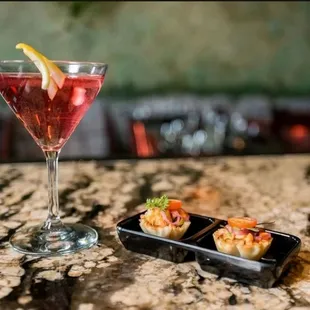 a drink and appetizer on a table