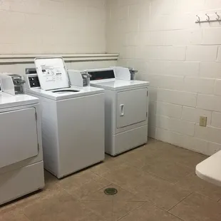 Two pairs of washer/dryer near bathroom