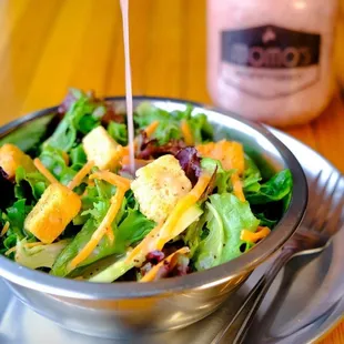 Fresh salad, featuring our Signature Momo&apos;s Poppyseed Salad Dressing