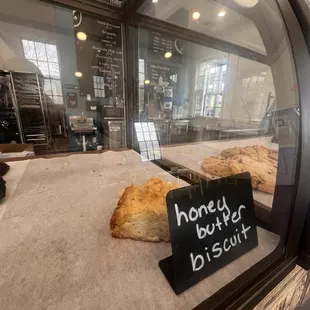 a bakery window with a sign that says honey burger biscuit