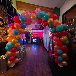 a colorful arch of balloons