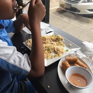 a boy eating at a restaurant