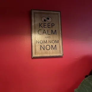 a sign on a red wall