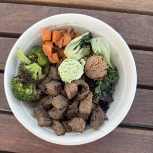 Tri tip beef bowl with a side of sweet potatoes, bok choy served over black rice and whole oats