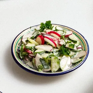 a bowl of salad and a plate of rice