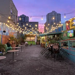 a patio with tables and chairs