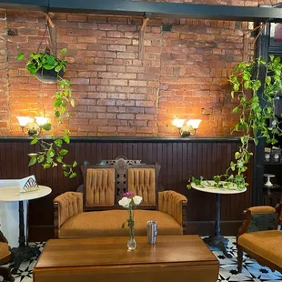 a brick wall with plants hanging from it
