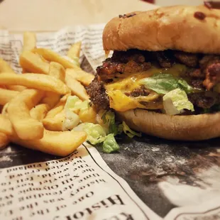 Al Pastor Burger with fries, it's a cheeseburger topped with carne al Pastor.
